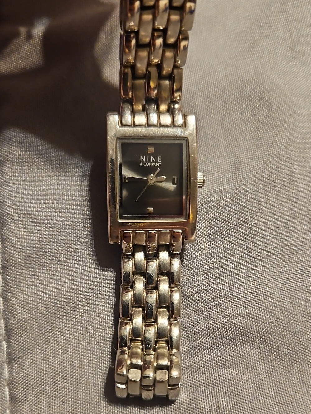 Nine & Co. Women's Silver Tone Bracelet Watch with Black Dial